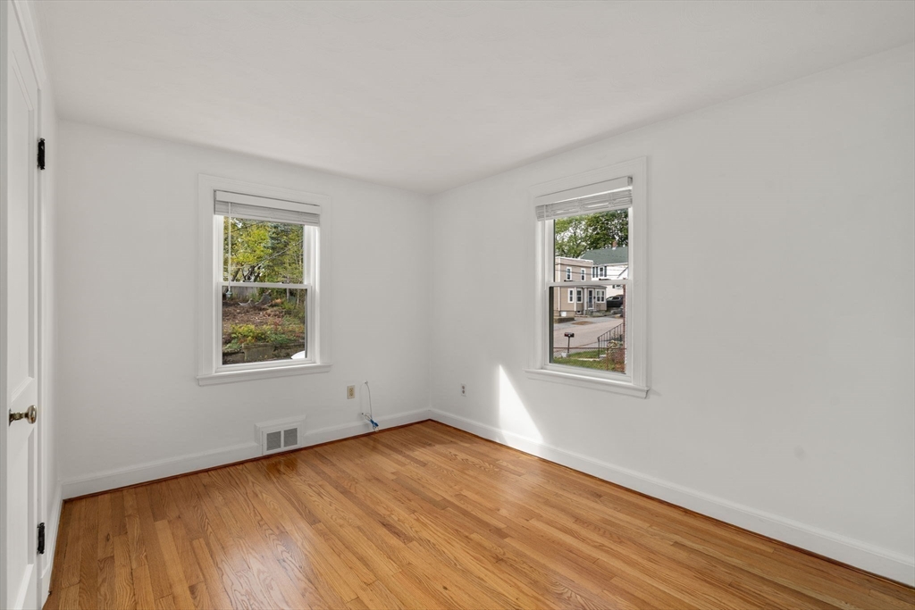 46 Bayard Street Dedham, MA 02026 - Photo 19 of 34 an empty room with wooden floor and windows