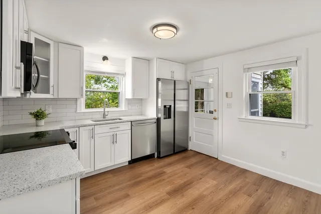 a kitchen with a refrigerator and a sink