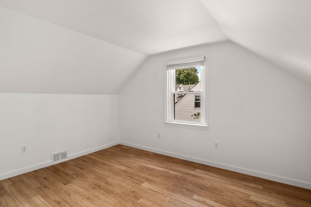 46 Bayard Street Dedham, MA 02026 - Photo 22 of 34 an empty room with wooden floor and window