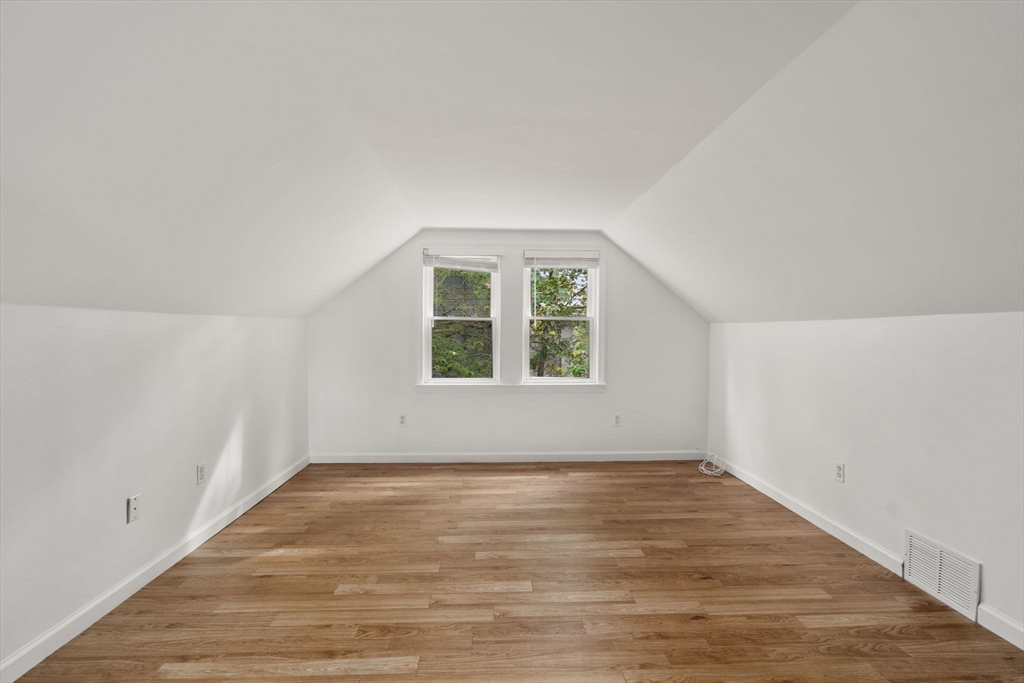 46 Bayard Street Dedham, MA 02026 - Photo 23 of 34 an empty room with wooden floor and windows