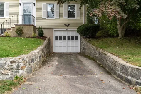 a view of a house with a yard and pathway