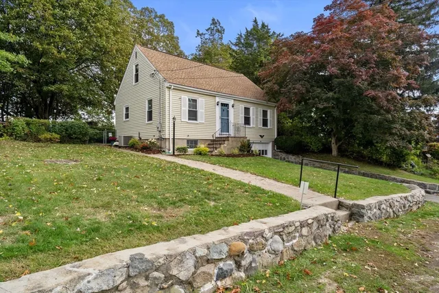 a view of a house with a yard and sitting area