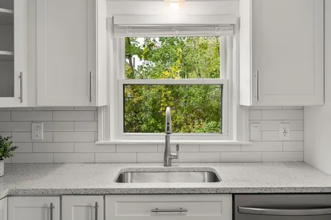 a kitchen with a sink and a window