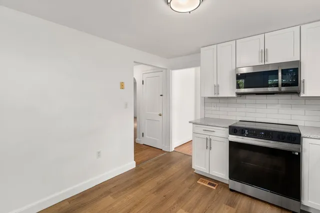 a kitchen with granite countertop wooden cabinets and stainless steel appliances