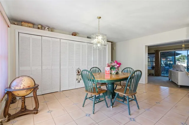 a kitchen with stainless steel appliances granite countertop a refrigerator a sink dishwasher a stove and white cabinets with wooden floor