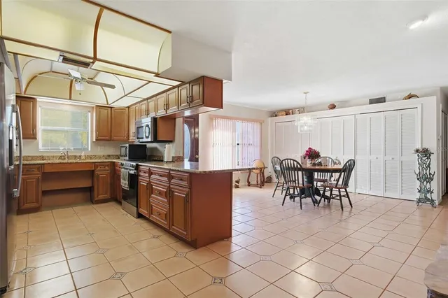 a kitchen with stainless steel appliances granite countertop a stove and cabinets
