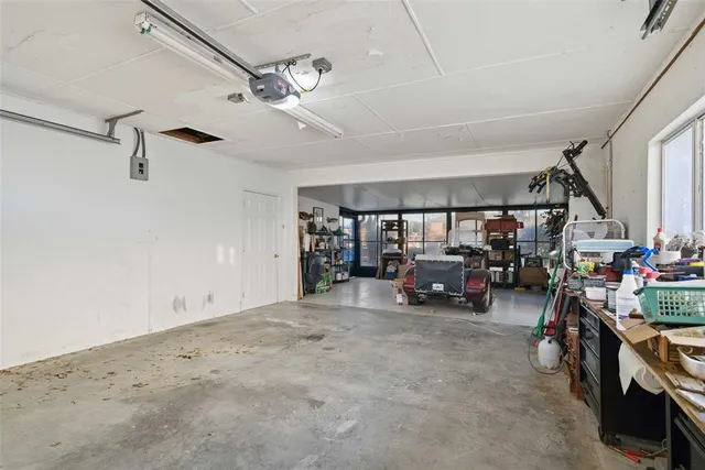 an aerial view of a houses with a lake