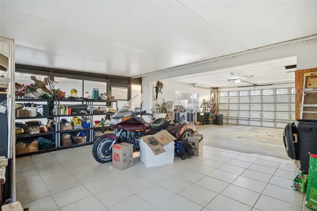 an aerial view of a house with swimming pool a yard and a fountain