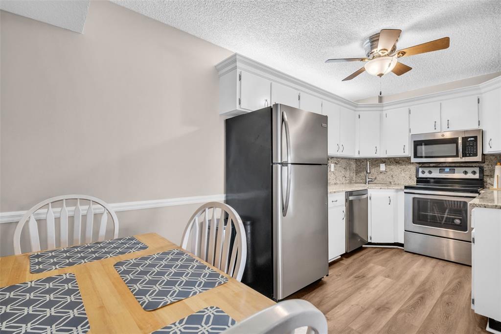 2523 Pine Ridge Way South, Unit C2 Palm Harbor, FL 34684 - Photo 14 of 29 a kitchen with a refrigerator and a stove top oven