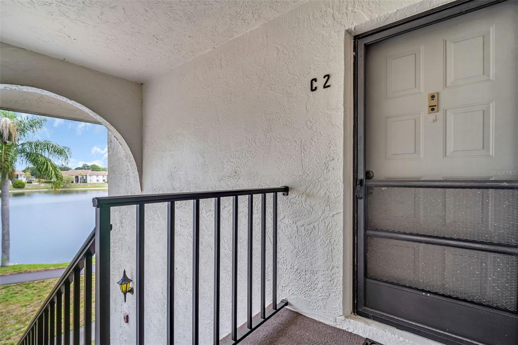 2523 Pine Ridge Way South, Unit C2 Palm Harbor, FL 34684 - Photo 3 of 29 a view of a hallway with wooden floor and staircase