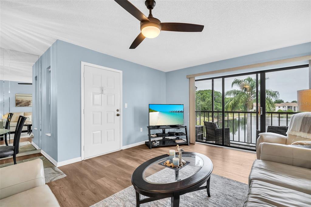 2523 Pine Ridge Way South, Unit C2 Palm Harbor, FL 34684 - Photo 5 of 29 a living room with furniture and a table