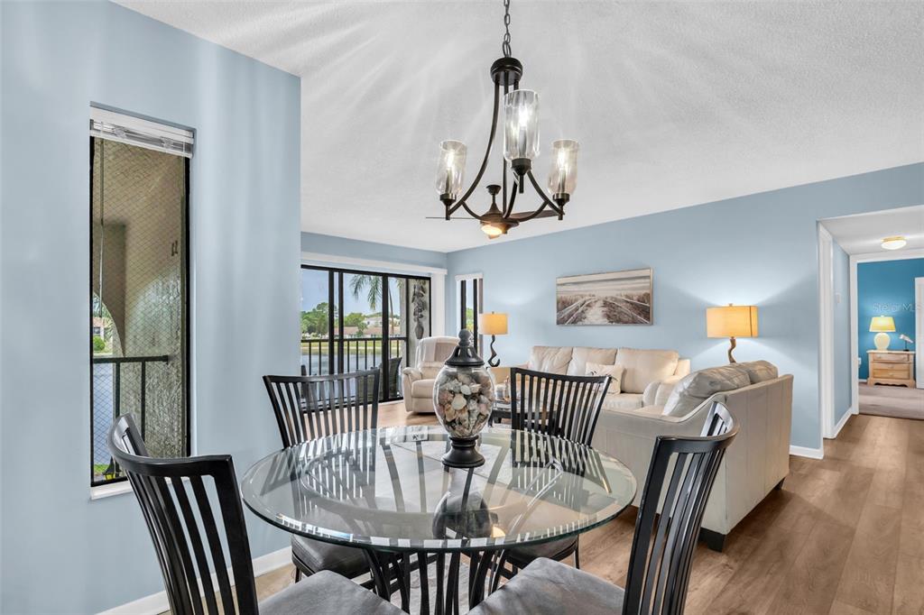 2523 Pine Ridge Way South, Unit C2 Palm Harbor, FL 34684 - Photo 10 of 29 a view of a dining room with furniture window and wooden floor