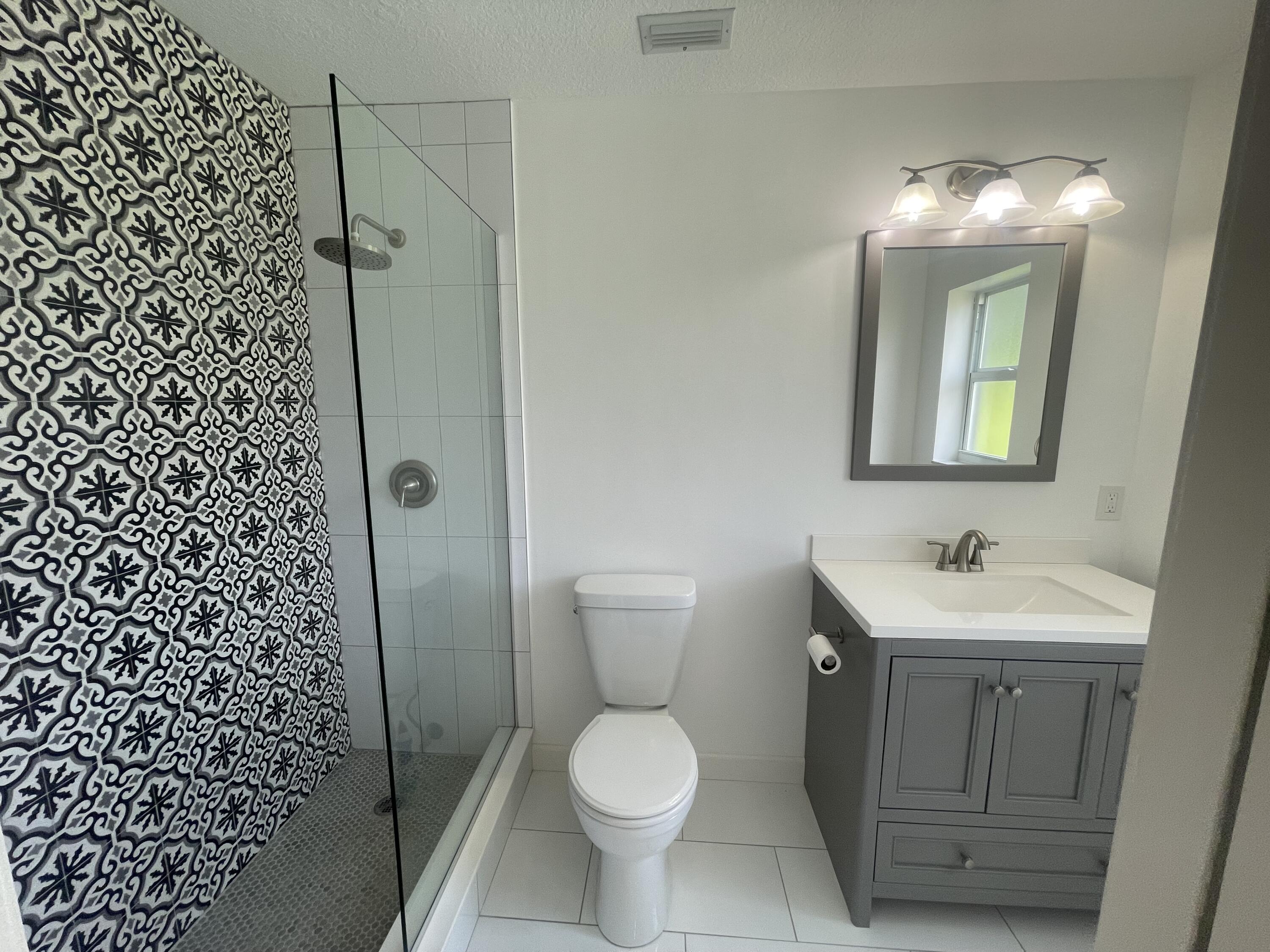 11737 Inverness Circle Wellington, FL 33414 - Photo 11 of 18 a bathroom with a toilet sink and mirror
