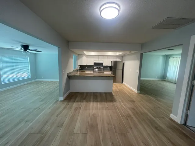 a kitchen with a sink and refrigerator