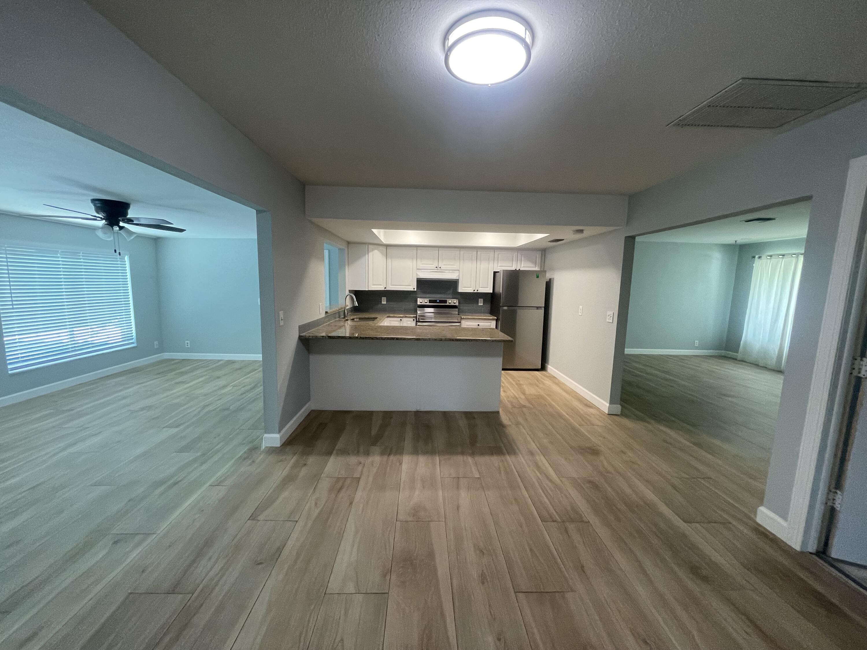 11737 Inverness Circle Wellington, FL 33414 - Photo 6 of 18 a kitchen with a sink and refrigerator