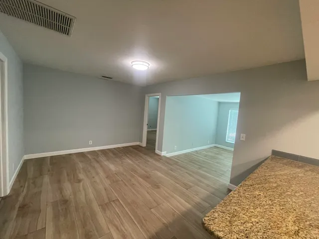 a view of an empty room and wooden floor