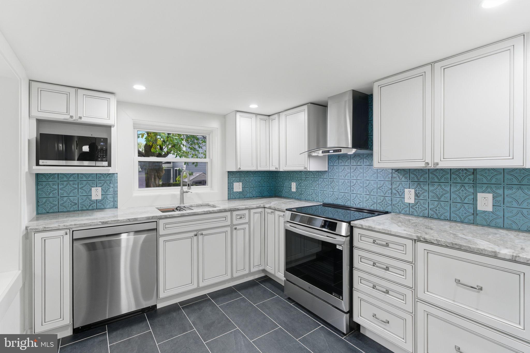 38 East 6th Street Frederick, MD 21701 - Photo 13 of 46 a kitchen with white cabinets stainless steel appliances and sink