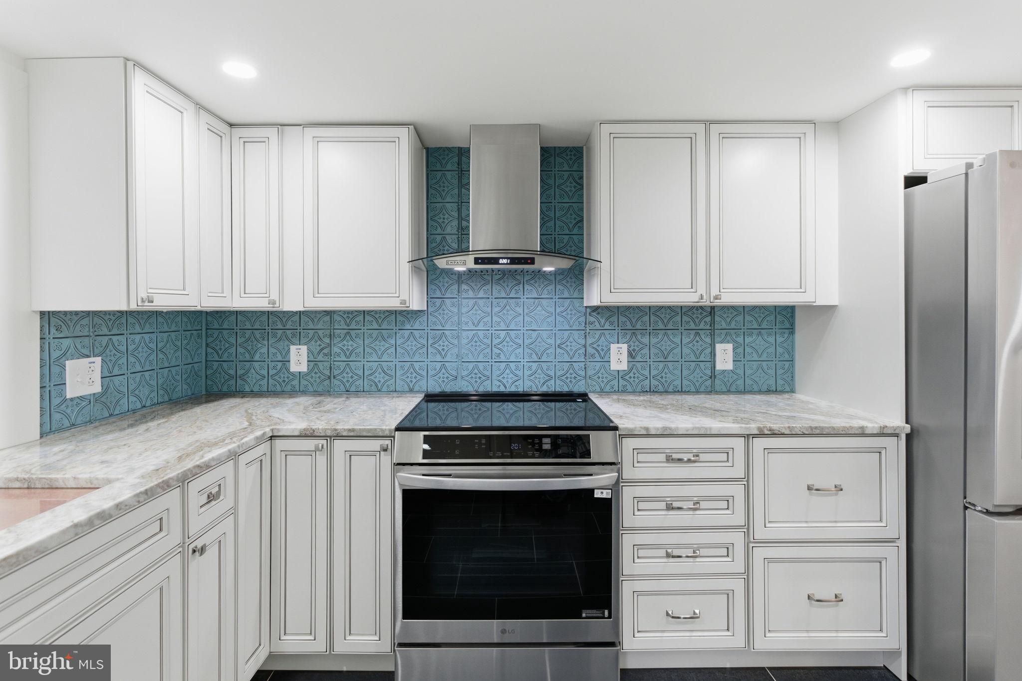 38 East 6th Street Frederick, MD 21701 - Photo 15 of 46 a kitchen with granite countertop white cabinets and stainless steel appliances