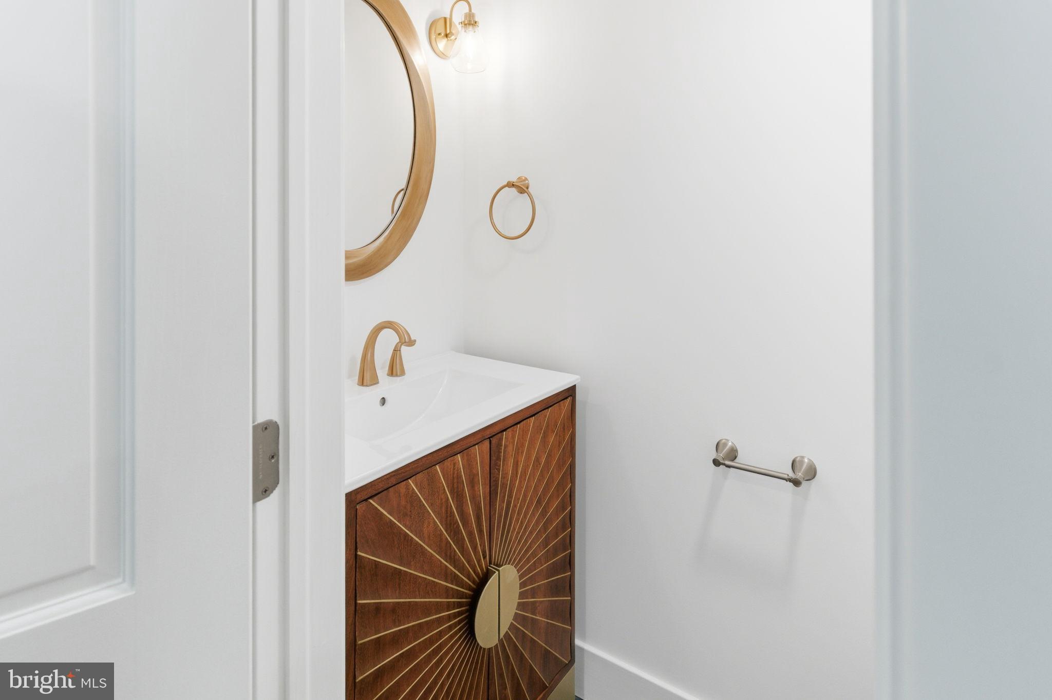 38 East 6th Street Frederick, MD 21701 - Photo 20 of 46 a bathroom with a sink and mirror