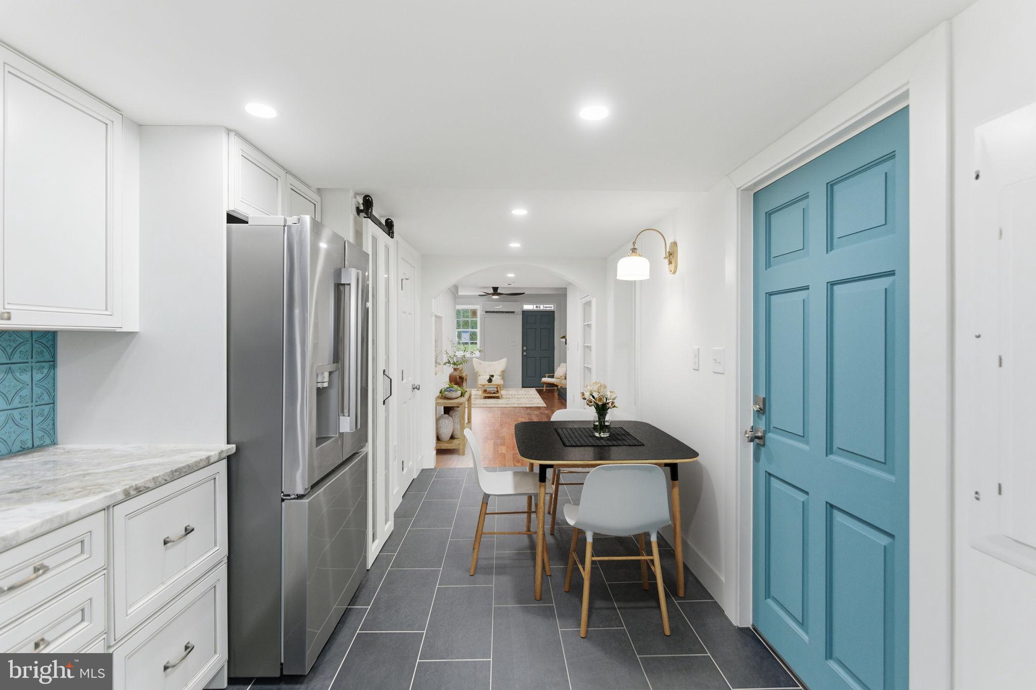 38 East 6th Street Frederick, MD 21701 - Photo 22 of 46 a kitchen with stainless steel appliances kitchen island granite countertop a refrigerator and a sink