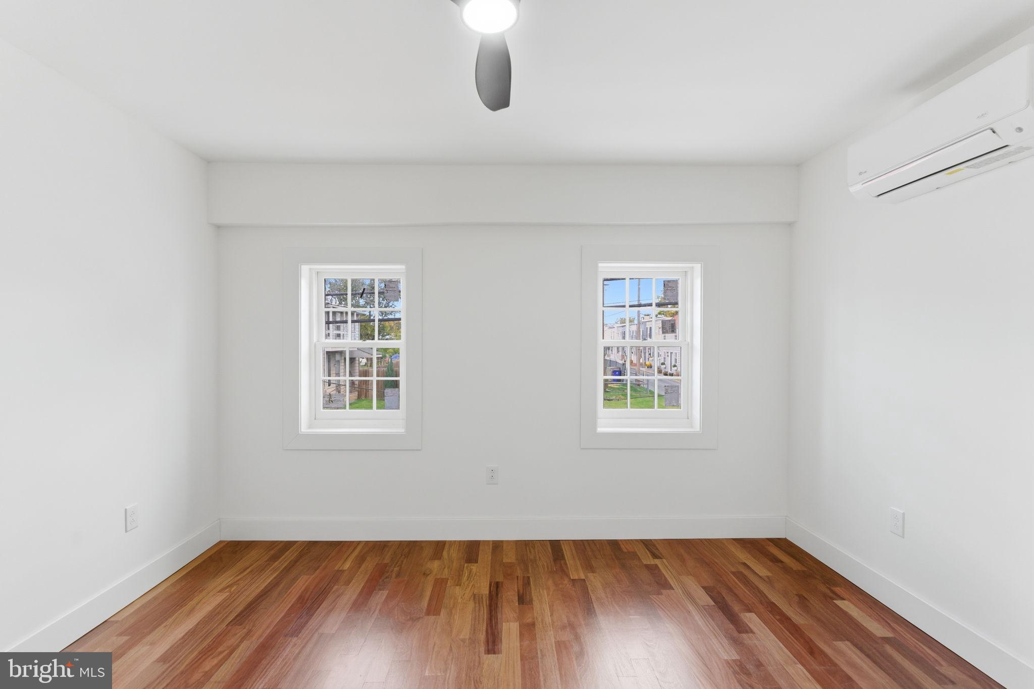 38 East 6th Street Frederick, MD 21701 - Photo 23 of 46 an empty room with wooden floor chandelier fan and windows