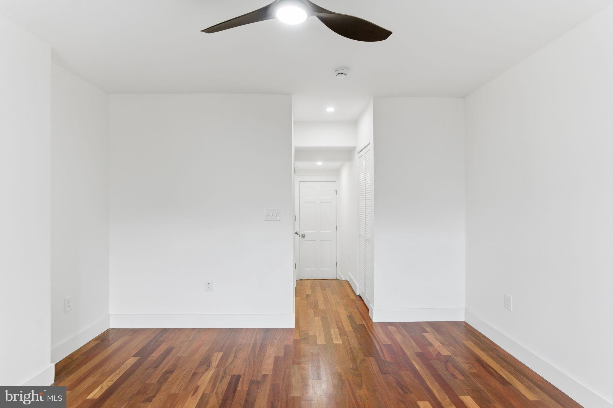 38 East 6th Street Frederick, MD 21701 - Photo 25 of 46 an empty room with wooden floor cabinet and a ceiling fan