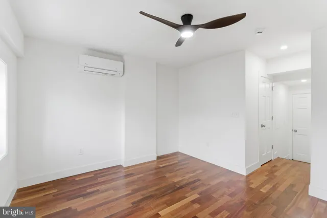 a bedroom with a bed and a mirror on the dresser