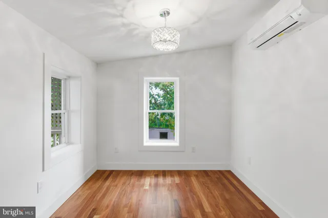 a bedroom with furniture and a flat screen tv