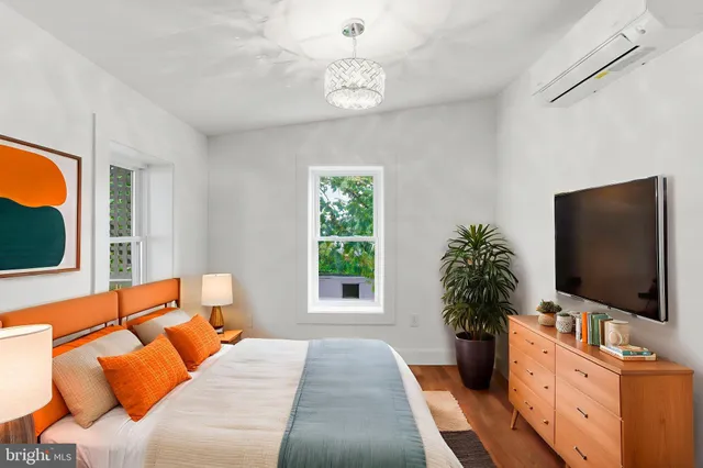 a view of bedroom with wooden floor