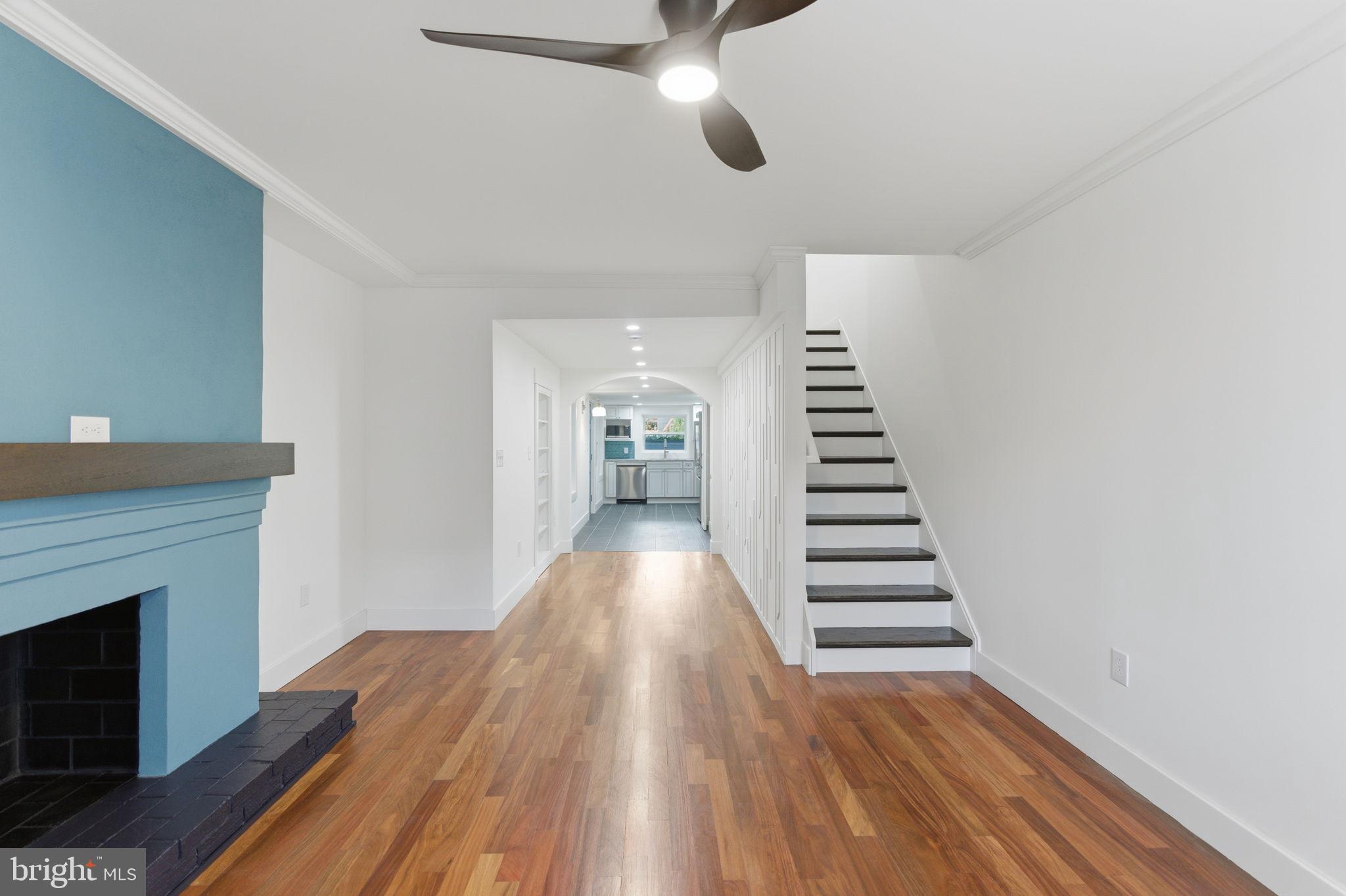 38 East 6th Street Frederick, MD 21701 - Photo 4 of 46 a view of a hallway with wooden floor and staircase