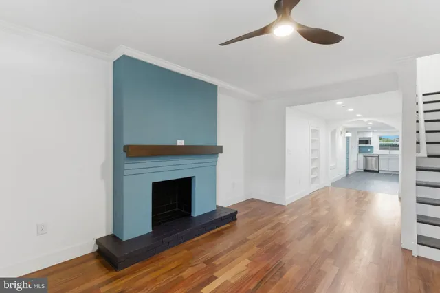 a view of empty room with wooden floor and fireplace
