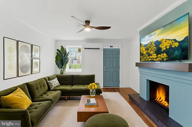 a view of empty room with wooden floor and fireplace