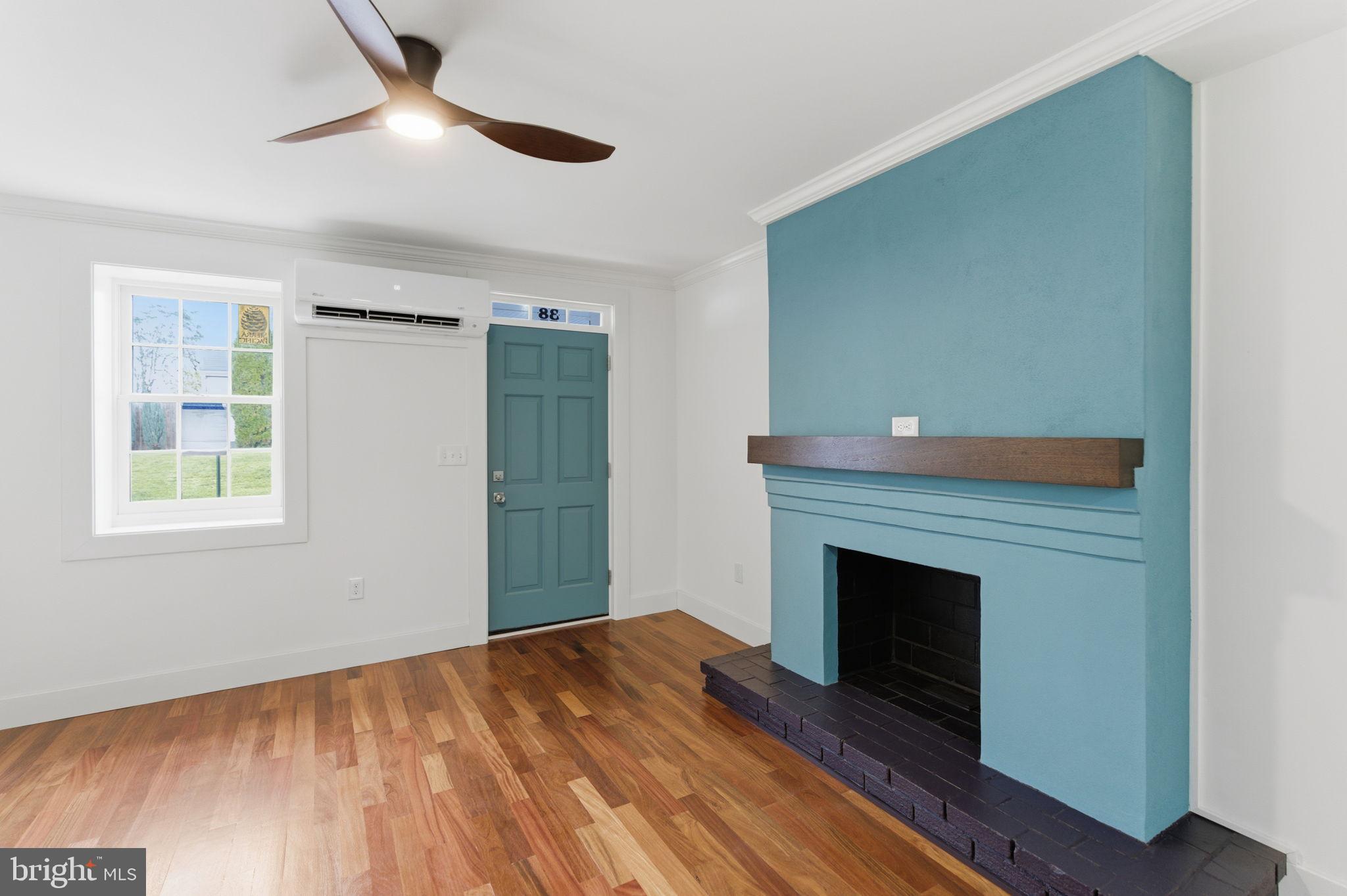 38 East 6th Street Frederick, MD 21701 - Photo 8 of 46 a view of empty room with wooden floor and fireplace