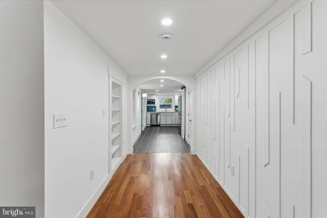 a view of a hallway with wooden floor and closet