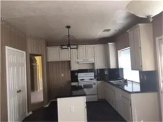 a kitchen with stainless steel appliances a refrigerator sink and cabinets