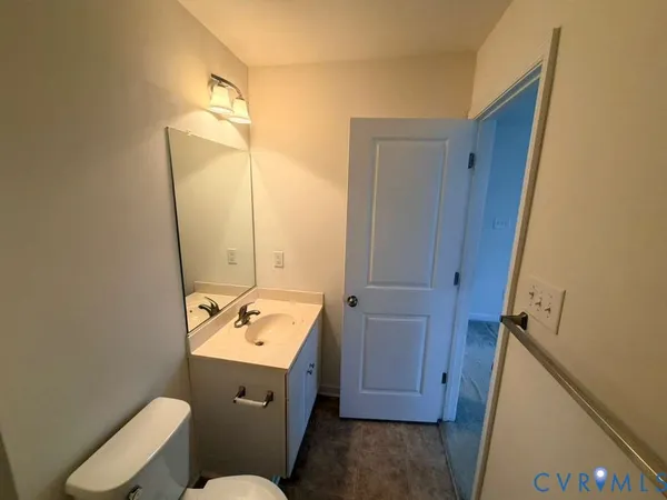 a bathroom with a sink mirror vanity and toilet