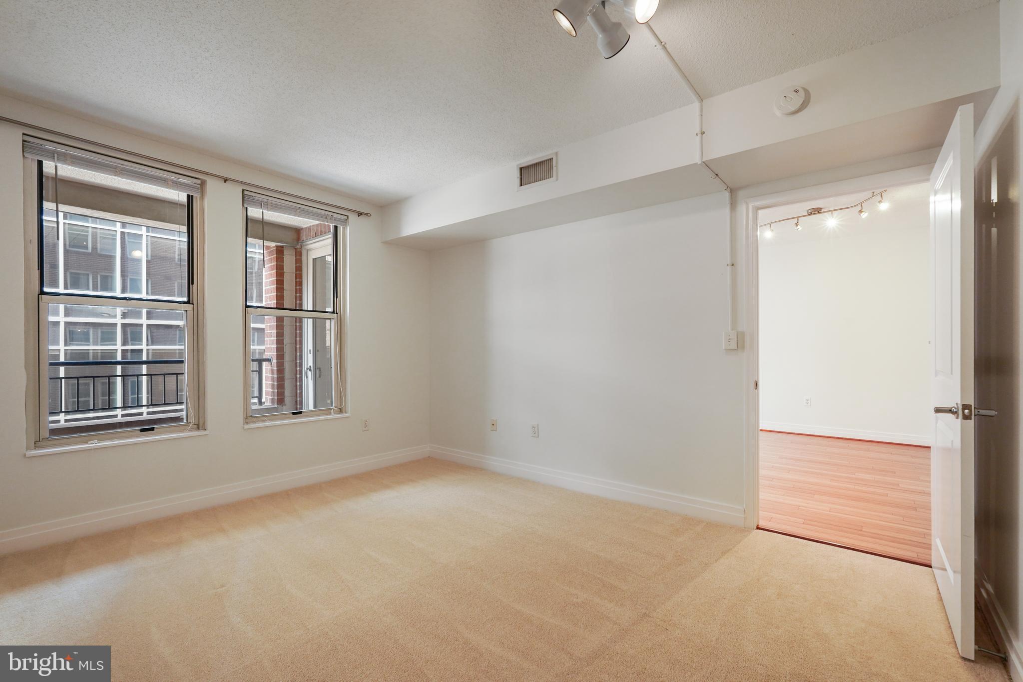 915 E Street Northwest, Unit 602 Washington, DC 20004 - Photo 12 of 23 an empty room with a empty space and windows