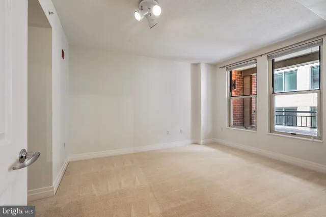 an empty room with a empty space and windows