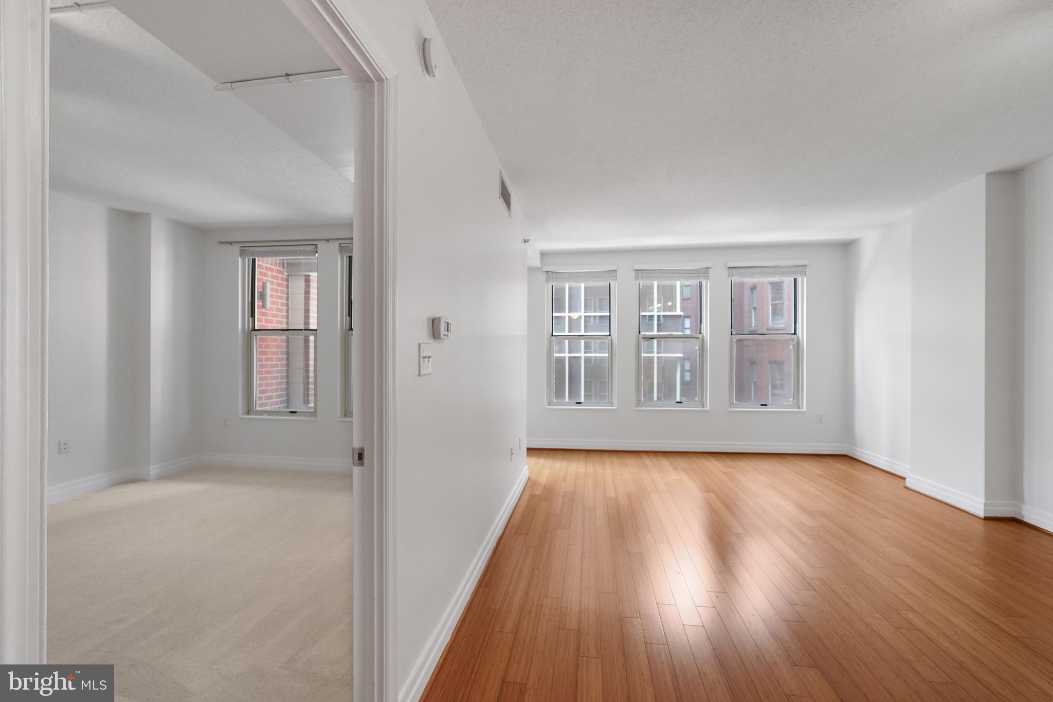 915 E Street Northwest, Unit 602 Washington, DC 20004 - Photo 7 of 23 a view of an empty room with wooden floor and a window