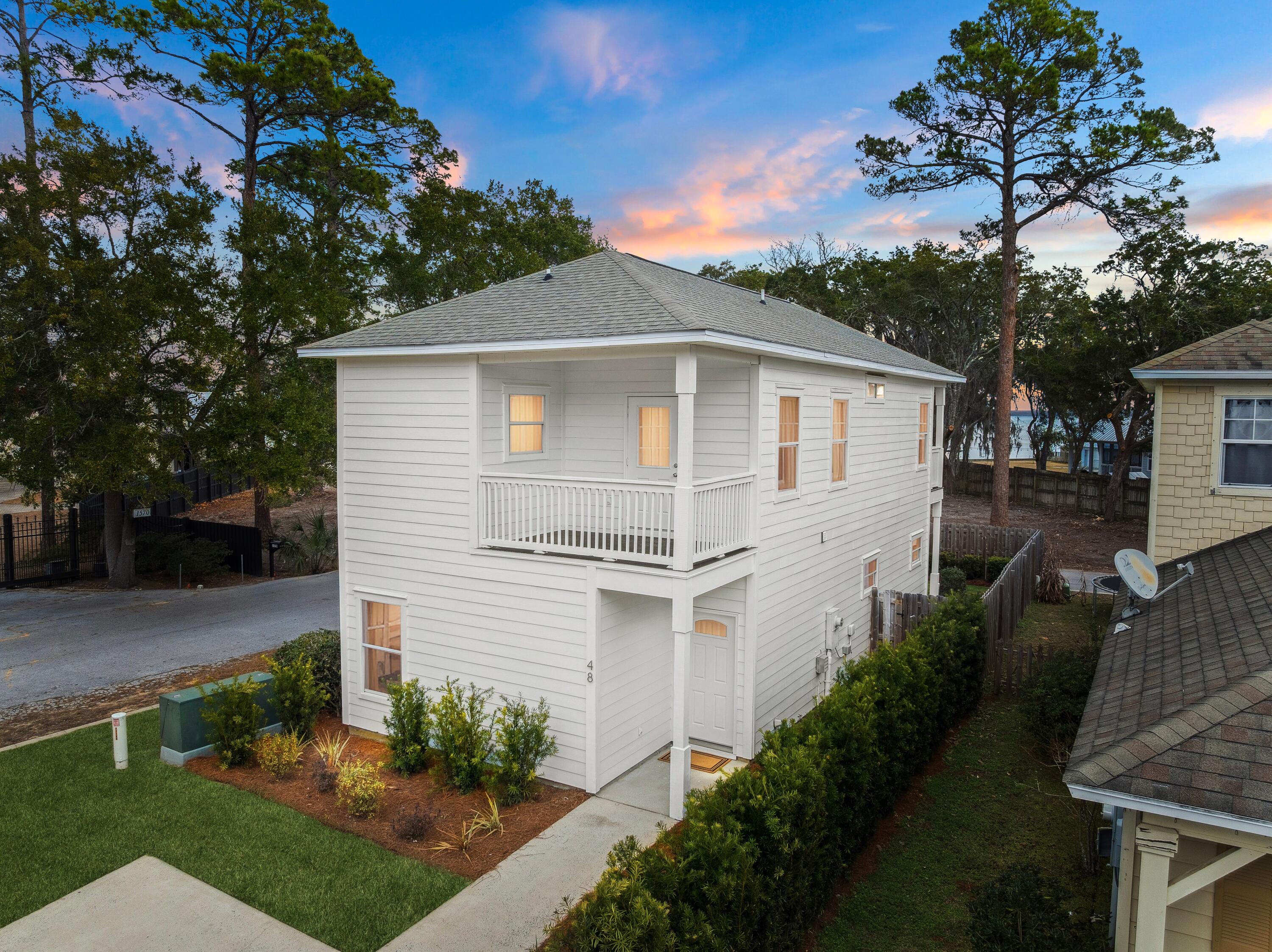 48 Pine Tree Way Santa Rosa Beach, FL 32459 - Photo 1 of 65 a front view of a house with a garden