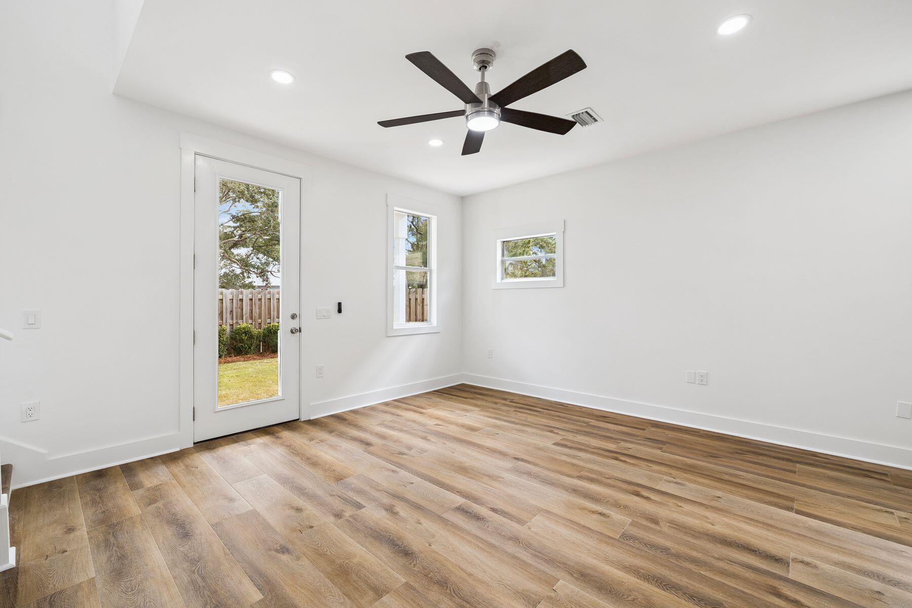 48 Pine Tree Way Santa Rosa Beach, FL 32459 - Photo 12 of 65 an empty room with wooden floor and windows