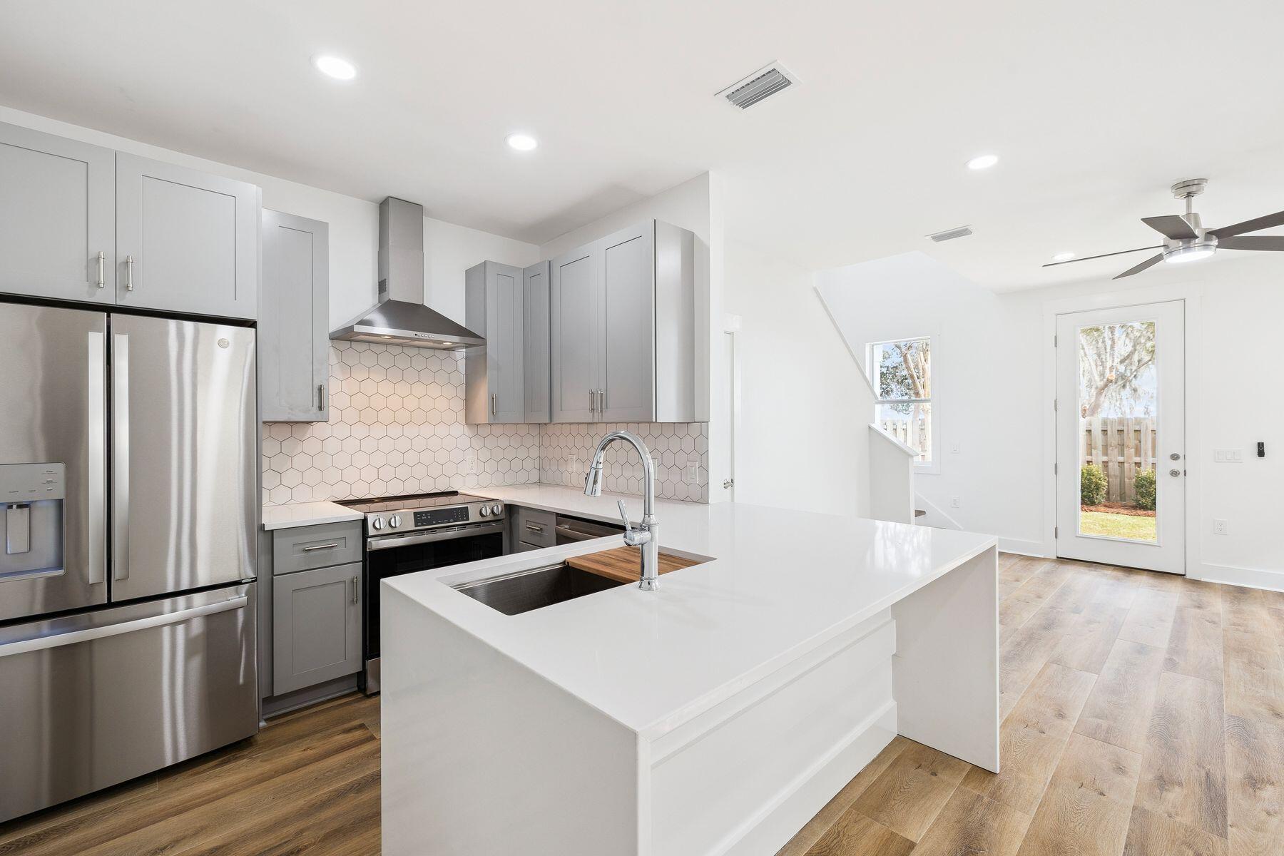 48 Pine Tree Way Santa Rosa Beach, FL 32459 - Photo 19 of 65 a kitchen with stainless steel appliances a refrigerator a sink and white cabinets