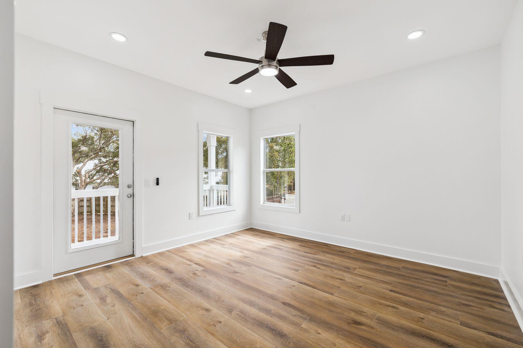 48 Pine Tree Way Santa Rosa Beach, FL 32459 - Photo 25 of 65 a view of a livingroom with wooden floor and a ceiling fan