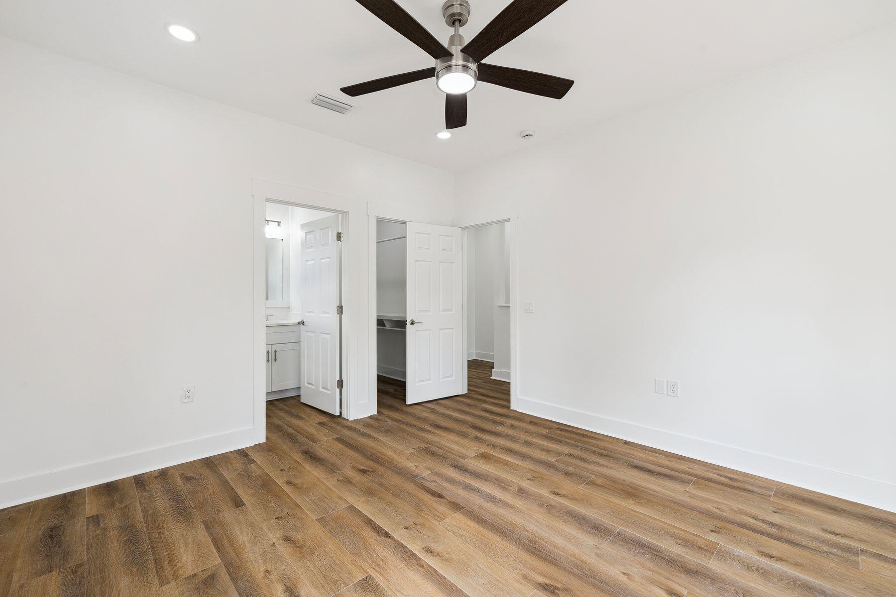 48 Pine Tree Way Santa Rosa Beach, FL 32459 - Photo 28 of 65 a view of a big room with wooden floor and a ceiling fan