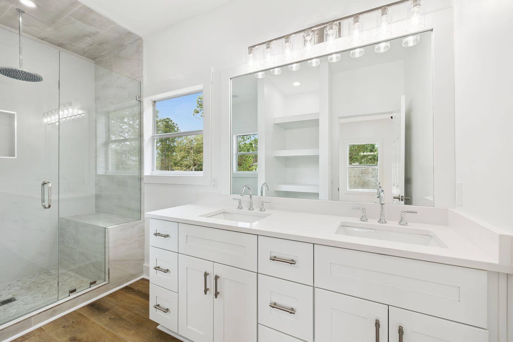 48 Pine Tree Way Santa Rosa Beach, FL 32459 - Photo 36 of 65 a bathroom with a shower sink and mirror