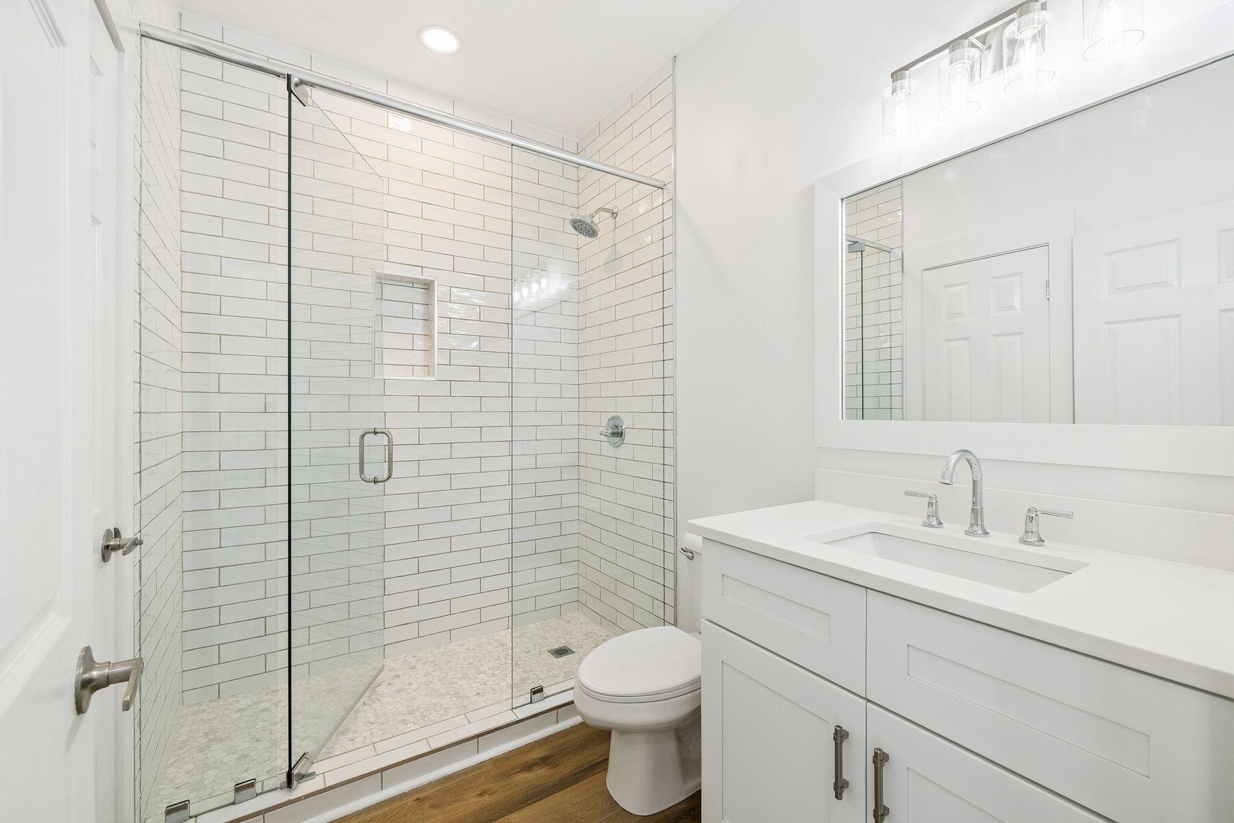 48 Pine Tree Way Santa Rosa Beach, FL 32459 - Photo 39 of 65 a bathroom with a shower sink vanity mirror and toilet