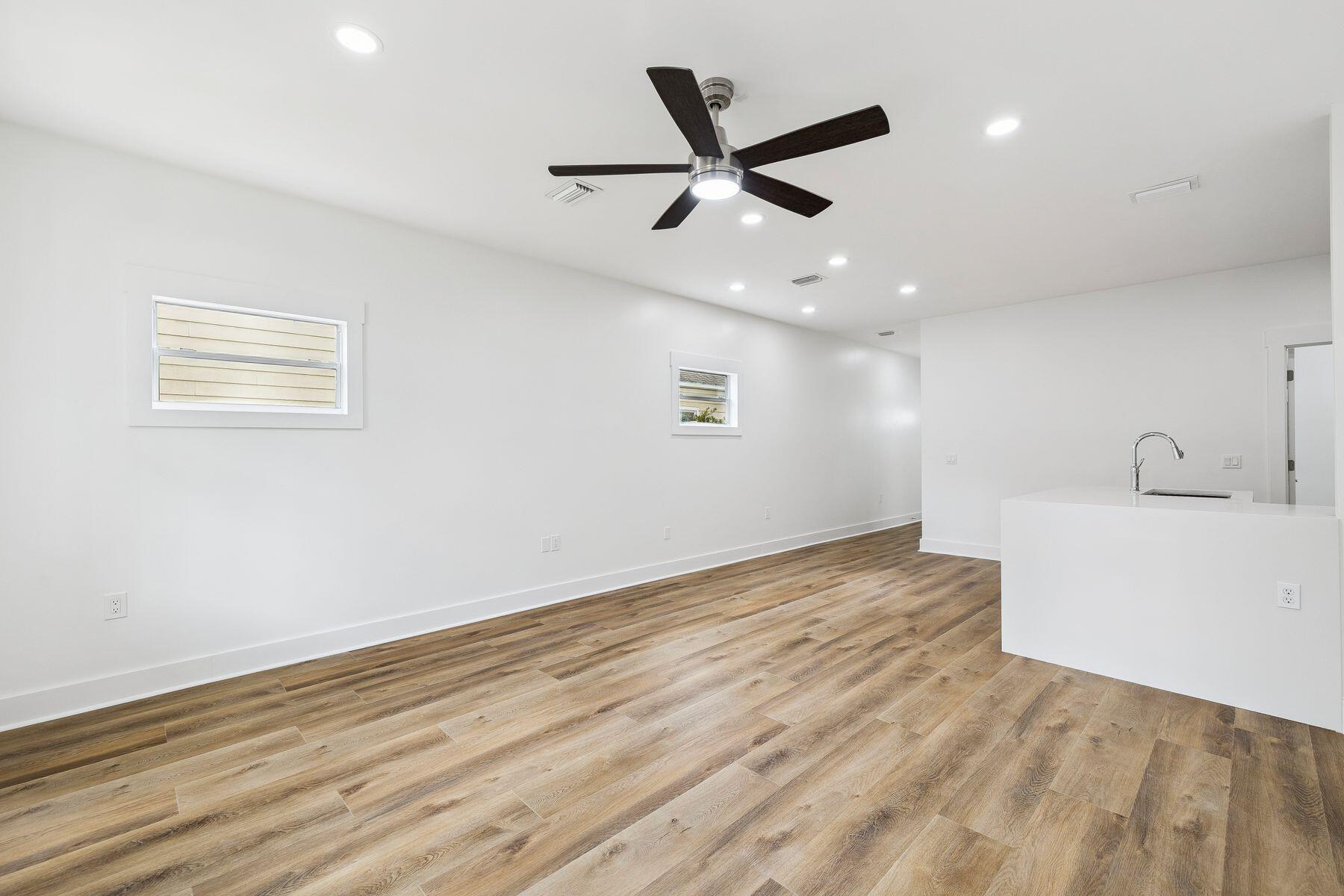 48 Pine Tree Way Santa Rosa Beach, FL 32459 - Photo 40 of 65 a view of an empty room with wooden floor and a ceiling fan