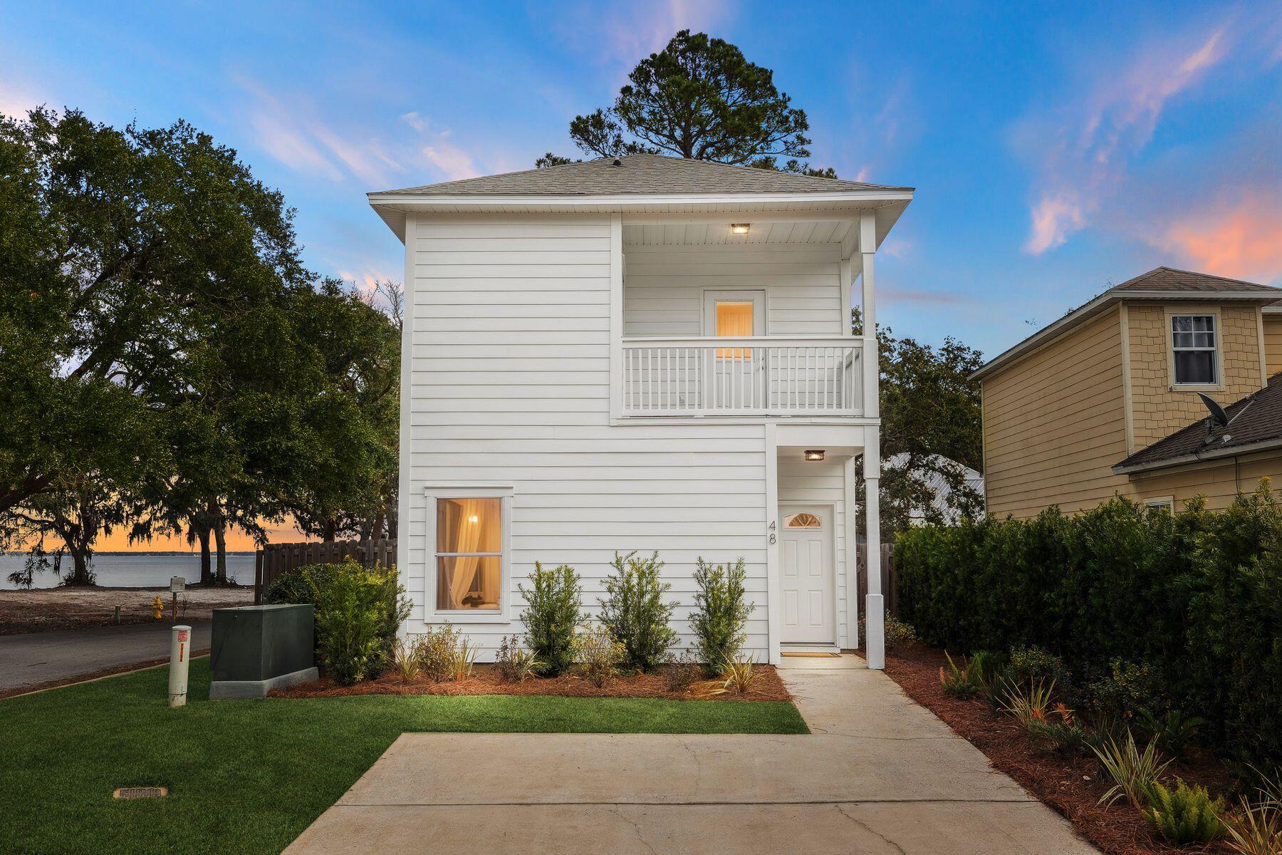 48 Pine Tree Way Santa Rosa Beach, FL 32459 - Photo 4 of 65 a front view of a house with a yard