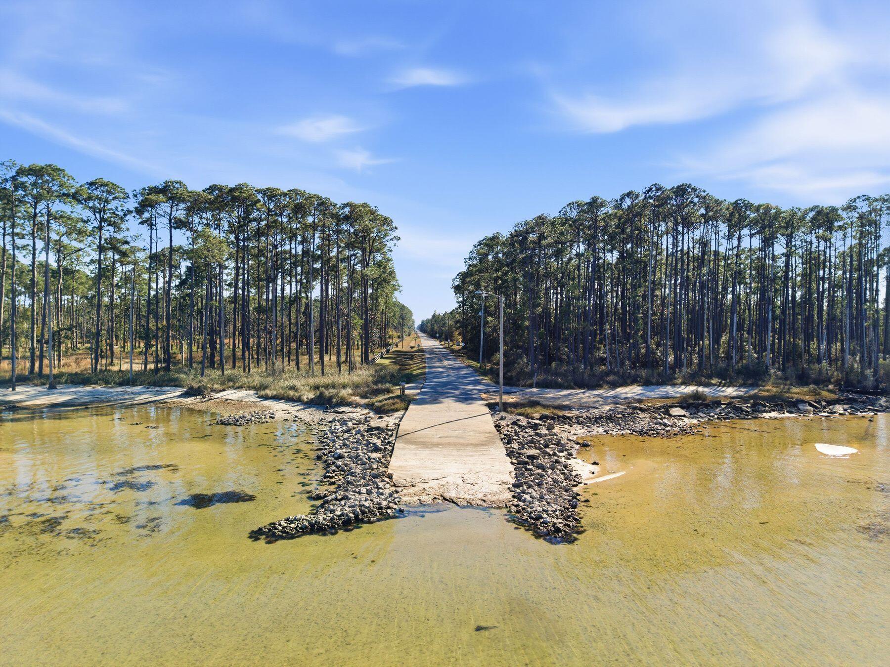 48 Pine Tree Way Santa Rosa Beach, FL 32459 - Photo 59 of 65 a view of swimming pool with outdoor seating and house in the background
