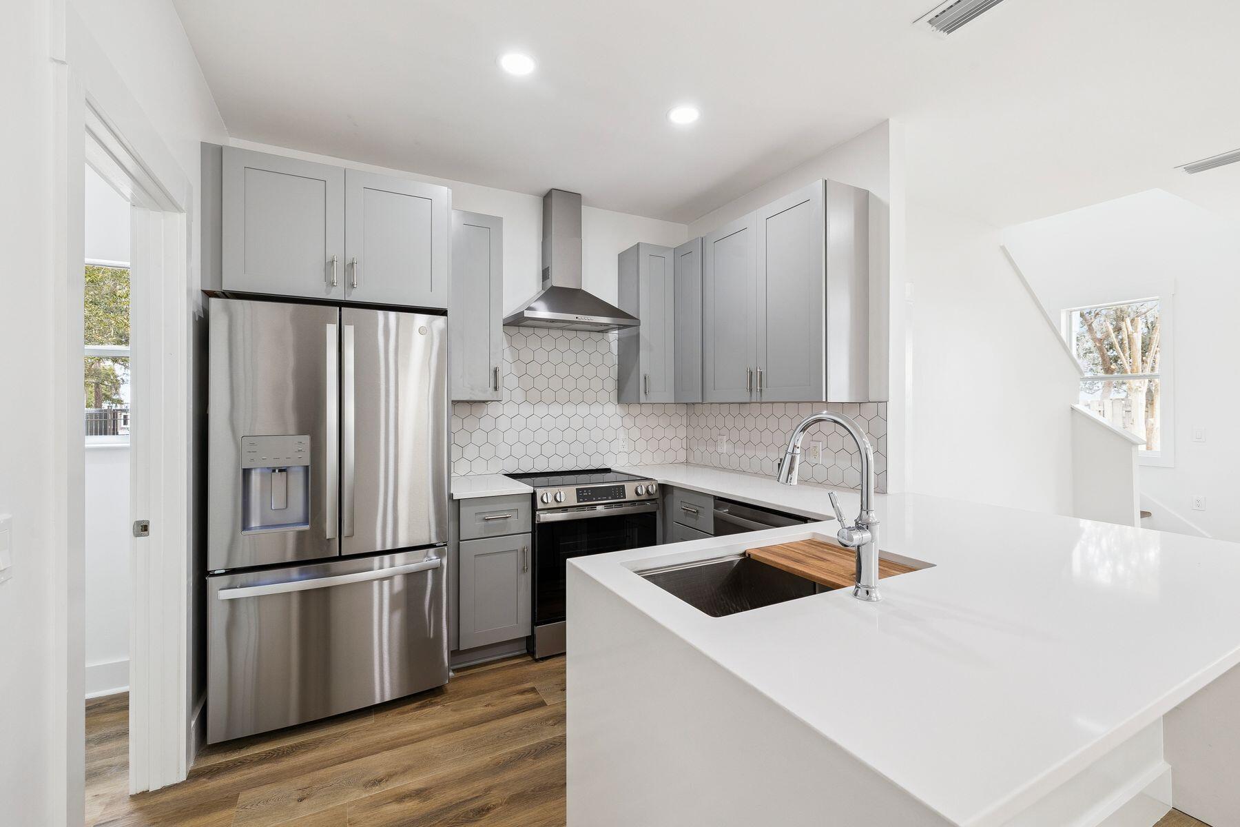 48 Pine Tree Way Santa Rosa Beach, FL 32459 - Photo 7 of 65 a kitchen with a sink a refrigerator and a stove top oven
